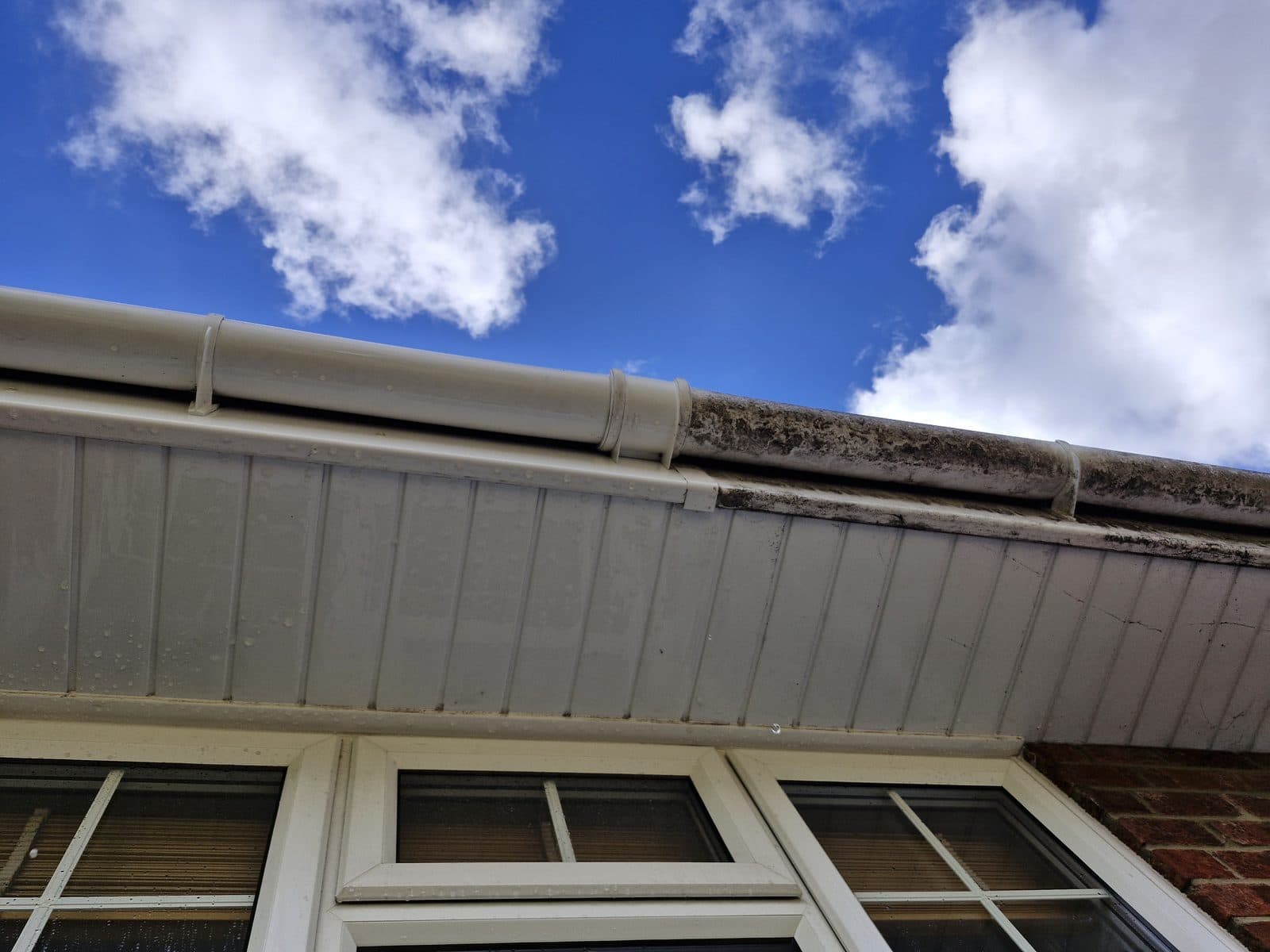 Clean white soffits and fascias under a blue sky.